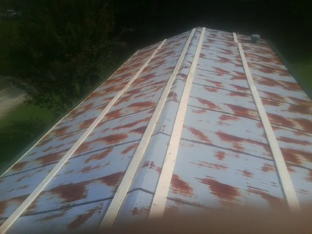 Rusted metal roof panels with new wood purlins before replacement — Storm Damage Roof Repair in Ben Lomond by Roofing Brothers